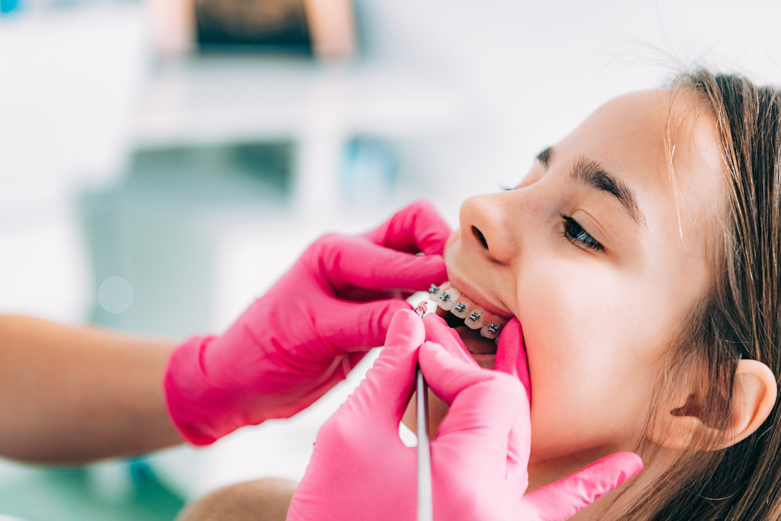 Orthodontist checking girl’s dental