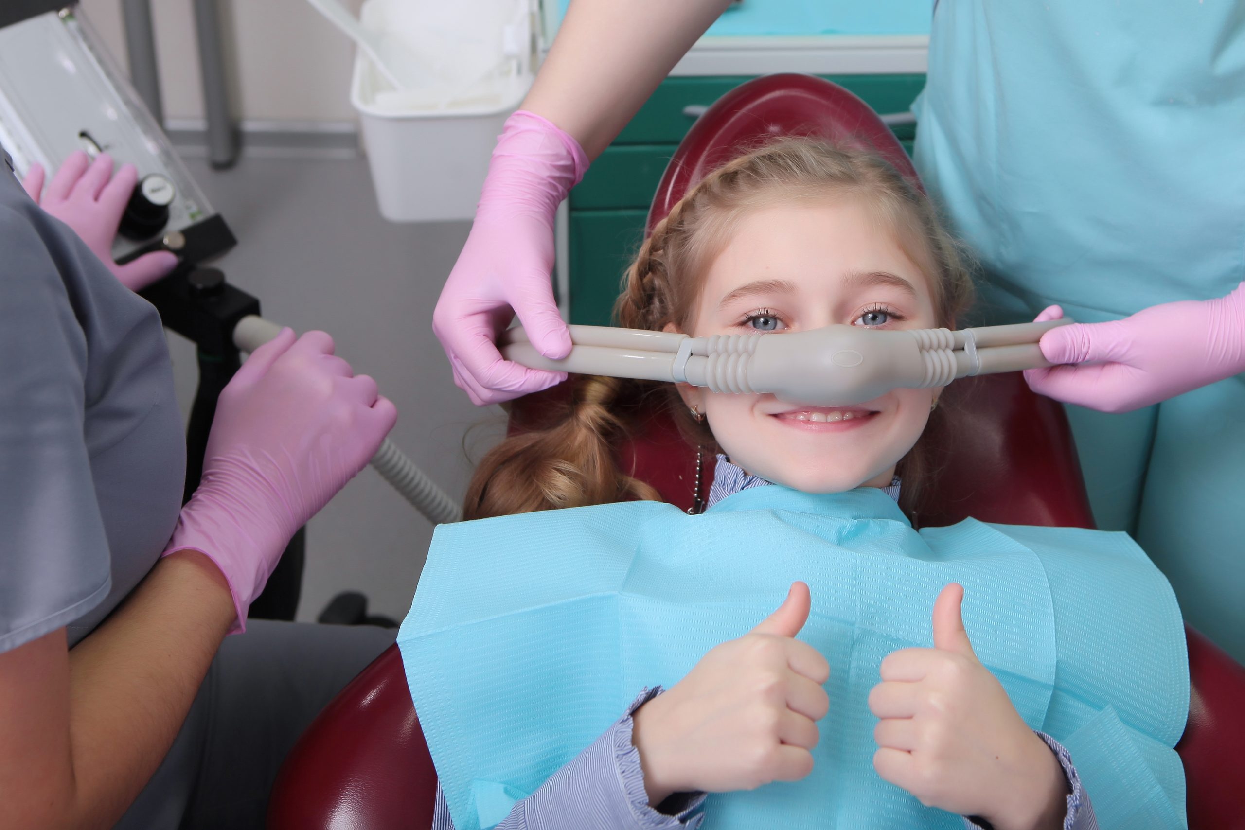 A little girl is comfortable to treat her teeth under superficial sedation