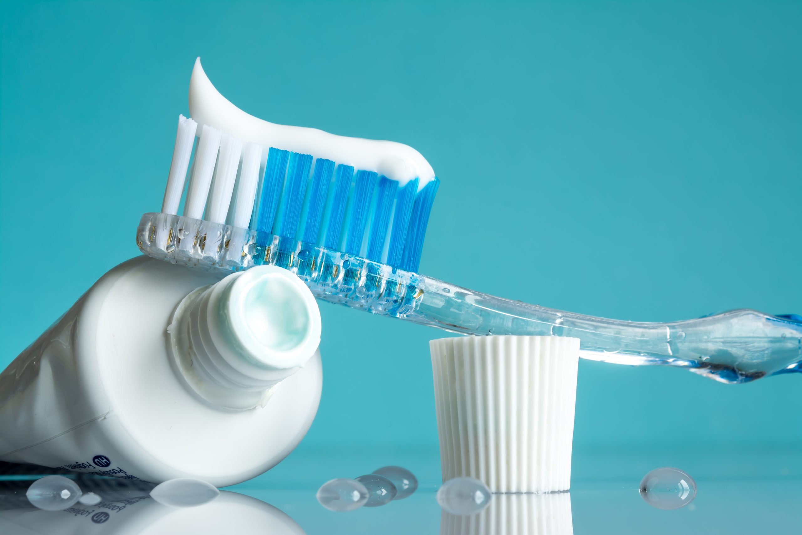 New toothbrush with toothpaste close-up in the bathroom on a mirror table